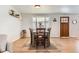 Dining area with wood floors and a table for six at 3720 S Hazel Ct, Englewood, CO 80110