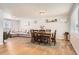 Open concept dining area with wood floors and a six-seat table at 3720 S Hazel Ct, Englewood, CO 80110