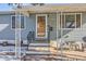 Inviting front entrance with covered porch and stone pathway at 3720 S Hazel Ct, Englewood, CO 80110