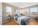 Bright bedroom with hardwood floors, large windows, and neutral colors at 658 Casper Dr, Lafayette, CO 80026