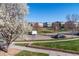 View of the well maintained neighborhood with grass, trees, and community residences at 658 Casper Dr, Lafayette, CO 80026