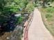Scenic creek with a small waterfall, stone embankment, and walking path at 658 Casper Dr, Lafayette, CO 80026