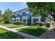 Attractive row of townhomes featuring blue and white exteriors with well-maintained landscaping and lawns at 658 Casper Dr, Lafayette, CO 80026