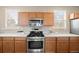 Close-up on kitchen range and cabinets, bright counters and natural light at 658 Casper Dr, Lafayette, CO 80026