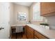 Kitchen desk area with storage, natural light, and neutral decor at 658 Casper Dr, Lafayette, CO 80026