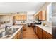 Efficient kitchen with gas range, built-in microwave, and desk area at 658 Casper Dr, Lafayette, CO 80026