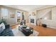 Cozy living room with fireplace, hardwood floors, access to balcony, and neutral tones at 658 Casper Dr, Lafayette, CO 80026