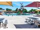 Community pool with slides, water features, lounge chairs, and picnic tables and umbrellas at 658 Casper Dr, Lafayette, CO 80026
