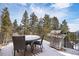 Outdoor deck featuring a dining set and grill, perfect for enjoying meals outdoors at 2120 Gross Dam Rd, Golden, CO 80403