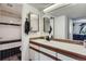 Well-maintained bathroom featuring a vanity with dual mirrors and tiled shower-tub combination at 10785 W 63Rd Pl # 202, Arvada, CO 80004