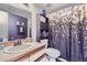 Chic bathroom with modern sink, vanity, and eye-catching shower curtain and dark accent wall at 10785 W 63Rd Pl # 202, Arvada, CO 80004