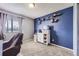 Inviting bedroom highlighted by neutral carpet, a bright window, and vibrant blue wall at 10785 W 63Rd Pl # 202, Arvada, CO 80004