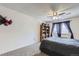 Bright bedroom with soft carpet, a ceiling fan, and natural light from a window at 10785 W 63Rd Pl # 202, Arvada, CO 80004