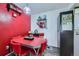 Cozy dining area with a retro red table, chairs, and vintage decor against a vibrant red wall at 10785 W 63Rd Pl # 202, Arvada, CO 80004
