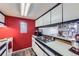 Efficient kitchen with white cabinets, laminate floors, and stainless steel sink and appliances at 10785 W 63Rd Pl # 202, Arvada, CO 80004