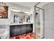 Elegant bathroom with dual sinks, dark cabinets, a tub, and glass-enclosed shower for spa-like experience at 3437 Rosato Dr # C, Highlands Ranch, CO 80126