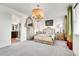 Spacious bedroom boasts plush carpet, a chandelier, and an en-suite bathroom for convenience at 3437 Rosato Dr # C, Highlands Ranch, CO 80126