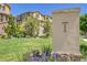 Community entrance with lush green lawn, landscaping, and elegant townhome buildings at 3437 Rosato Dr # C, Highlands Ranch, CO 80126