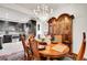 Elegant dining room features a chandelier, a wooden china cabinet, and a hardwood dining table at 3437 Rosato Dr # C, Highlands Ranch, CO 80126