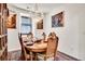 Charming dining room with chandelier, hardwood table, and a rug that enhances the room's decor at 3437 Rosato Dr # C, Highlands Ranch, CO 80126