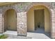 Covered entryway with elegant stone archways leading to a welcoming front door at 3437 Rosato Dr # C, Highlands Ranch, CO 80126