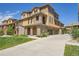 Charming multi-story home featuring stone accents, a three-car garage, and a well-maintained lawn at 3437 Rosato Dr # C, Highlands Ranch, CO 80126