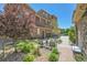 Inviting front yard with seating, garden, and brick accents leading to townhome garages at 3437 Rosato Dr # C, Highlands Ranch, CO 80126