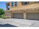 Spacious two-car garage with stone accents, enhancing curb appeal and providing ample parking at 3437 Rosato Dr # C, Highlands Ranch, CO 80126