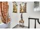 Hallway area with decorative tapestries, a table, and a door leading to an outdoor balcony at 3437 Rosato Dr # C, Highlands Ranch, CO 80126