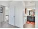 Hallway view leading to a bathroom with a dark vanity and patterned rug, blending style and functionality at 3437 Rosato Dr # C, Highlands Ranch, CO 80126