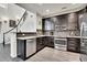 Well-appointed kitchen with modern appliances and dark cabinets at 3437 Rosato Dr # C, Highlands Ranch, CO 80126