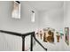 White staircase with dark wood railing and wall sconces leading to the upper level at 3437 Rosato Dr # C, Highlands Ranch, CO 80126