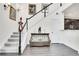 Elegant staircase with dark wood railing, leading to the upper level of home at 3437 Rosato Dr # C, Highlands Ranch, CO 80126