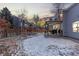 Spacious backyard featuring a play structure, patio area, and partially snow-covered lawn, perfect for outdoor enjoyment at 18233 E Dorado Ave, Centennial, CO 80015