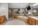 Elegant bathroom with tiled floors, a glass shower, a large tub, and dual vanities at 18233 E Dorado Ave, Centennial, CO 80015