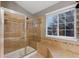 Elegant bathroom with a glass shower, a large tub, and a window view at 18233 E Dorado Ave, Centennial, CO 80015