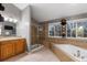 Elegant bathroom with tiled floors, a glass shower, a large tub, and dual windows at 18233 E Dorado Ave, Centennial, CO 80015