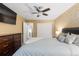 Comfortable bedroom featuring a ceiling fan, a TV and soft blue bedding with an ensuite bathroom down the hall at 18233 E Dorado Ave, Centennial, CO 80015