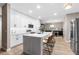 Bright kitchen with white cabinetry, stainless steel appliances, and an island with seating at 18233 E Dorado Ave, Centennial, CO 80015