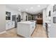 Bright kitchen with white cabinetry, stainless steel appliances, and an island with seating at 18233 E Dorado Ave, Centennial, CO 80015