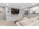 A comfortable living room features built in shelves, a large screen TV, and comfortable, white furniture at 18233 E Dorado Ave, Centennial, CO 80015