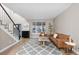 Open-concept living room featuring neutral walls, light wood floors and natural light at 18233 E Dorado Ave, Centennial, CO 80015