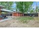 View of a backyard with a well manicured lawn, patio set and detached garage at 4841 Alcott St, Denver, CO 80221