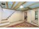 Basement area featuring laundry, storage, and access to stairs, and a decorative area rug at 4841 Alcott St, Denver, CO 80221