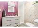 Stylish powder room with granite countertop, unique floral wallpaper, and modern fixtures at 4841 Alcott St, Denver, CO 80221