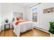 Bright bedroom with hardwood floors, a large window, and white walls offering a clean and airy feel at 4841 Alcott St, Denver, CO 80221