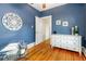 Charming bedroom with hardwood floors, a large window, and a decorative round design on the wall at 4841 Alcott St, Denver, CO 80221