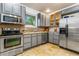 Well-equipped kitchen with stainless steel appliances, gray cabinets, and tile backsplash at 4841 Alcott St, Denver, CO 80221
