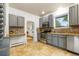 Bright kitchen with stainless steel appliances, ample counter space, and neutral tile flooring at 4841 Alcott St, Denver, CO 80221