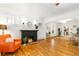 Charming living room with hardwood floors, brick fireplace, and arched doorway to dining area at 4841 Alcott St, Denver, CO 80221
